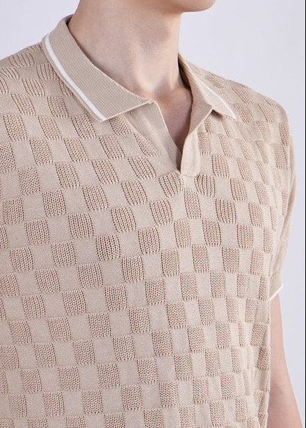 Man wearing a beige checkered shirt on a white background