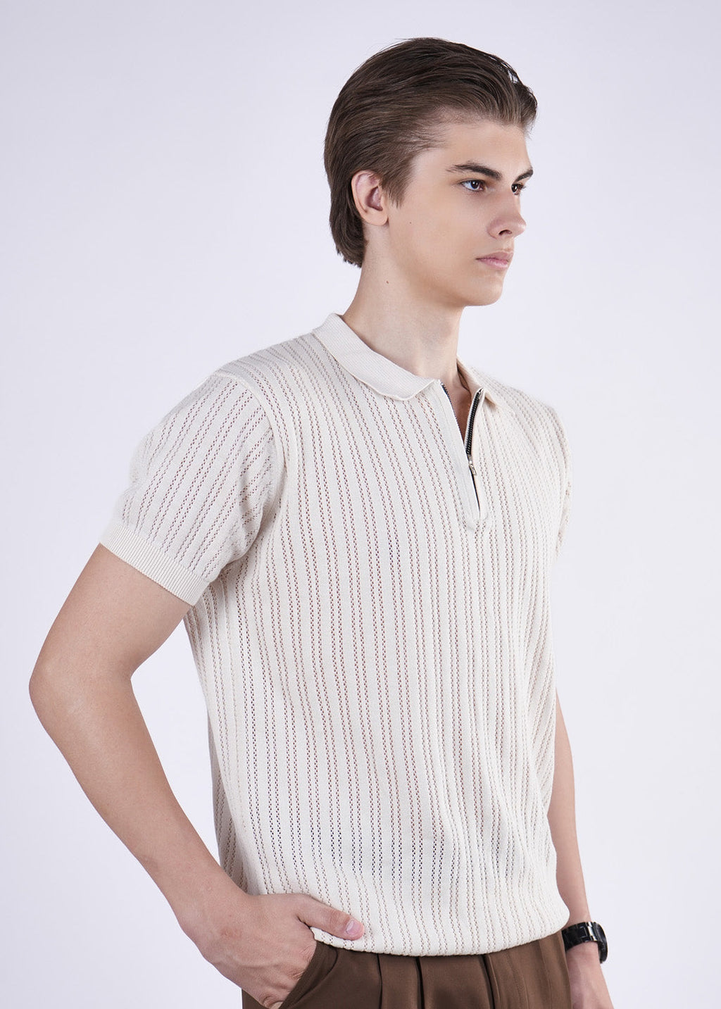 Man wearing a white textured shirt on a light gray background