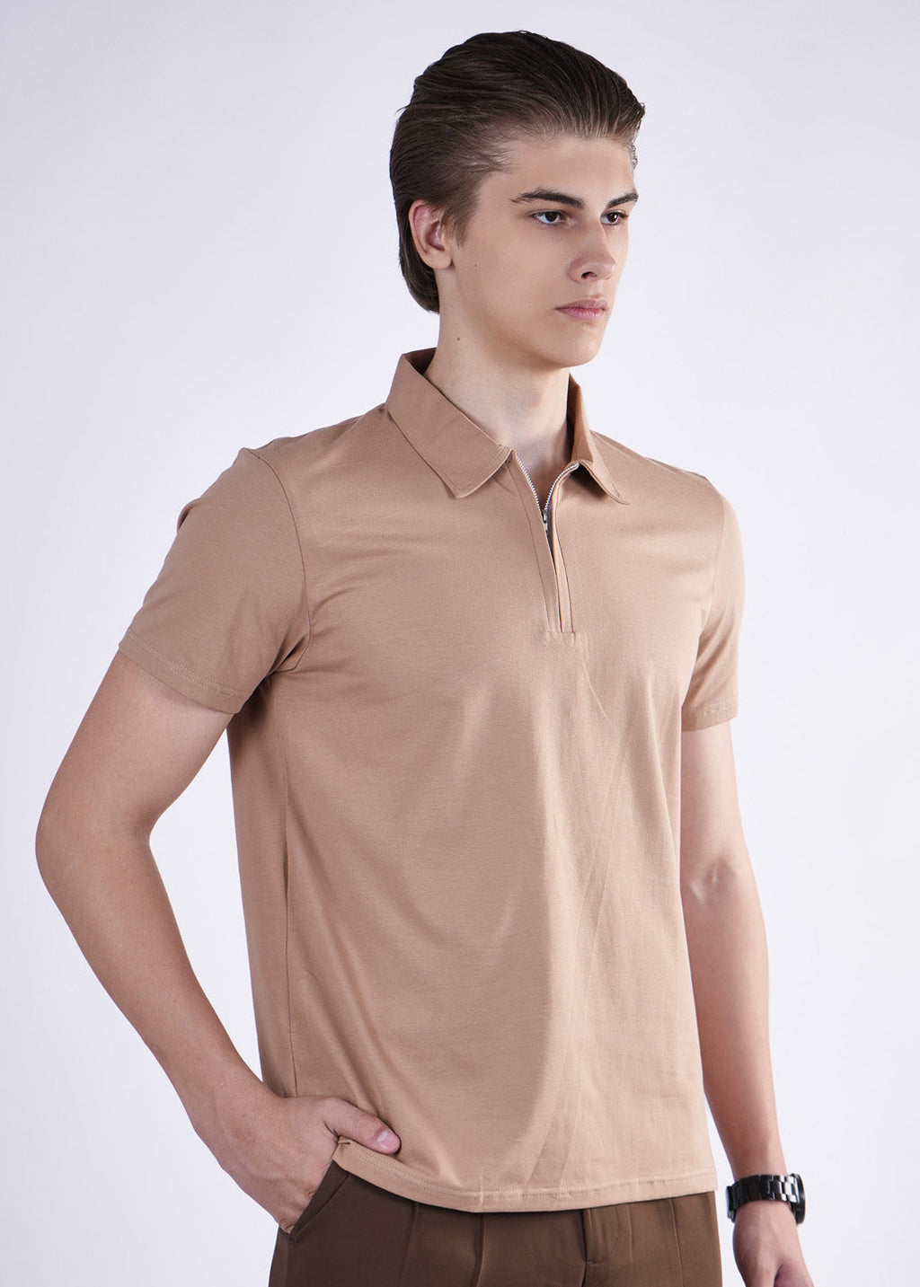 Man wearing a beige polo shirt on a white background