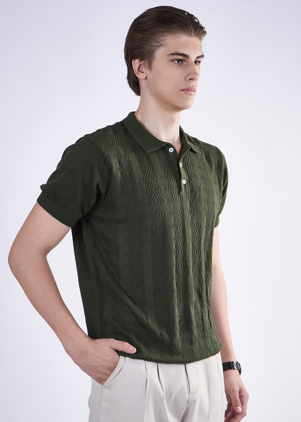 Man wearing a green knitted polo shirt on a white background