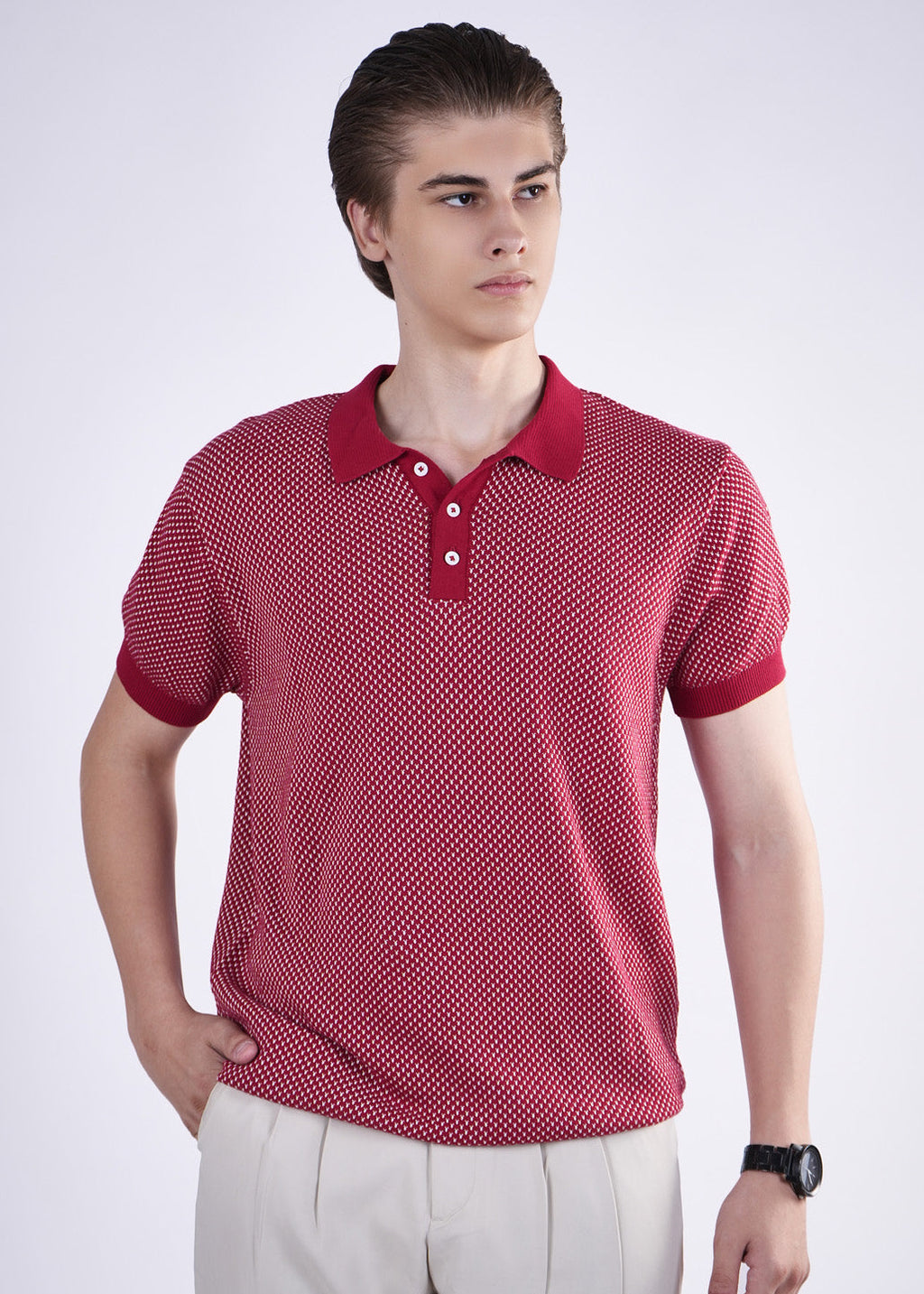 Man wearing a red patterned polo shirt on a white background