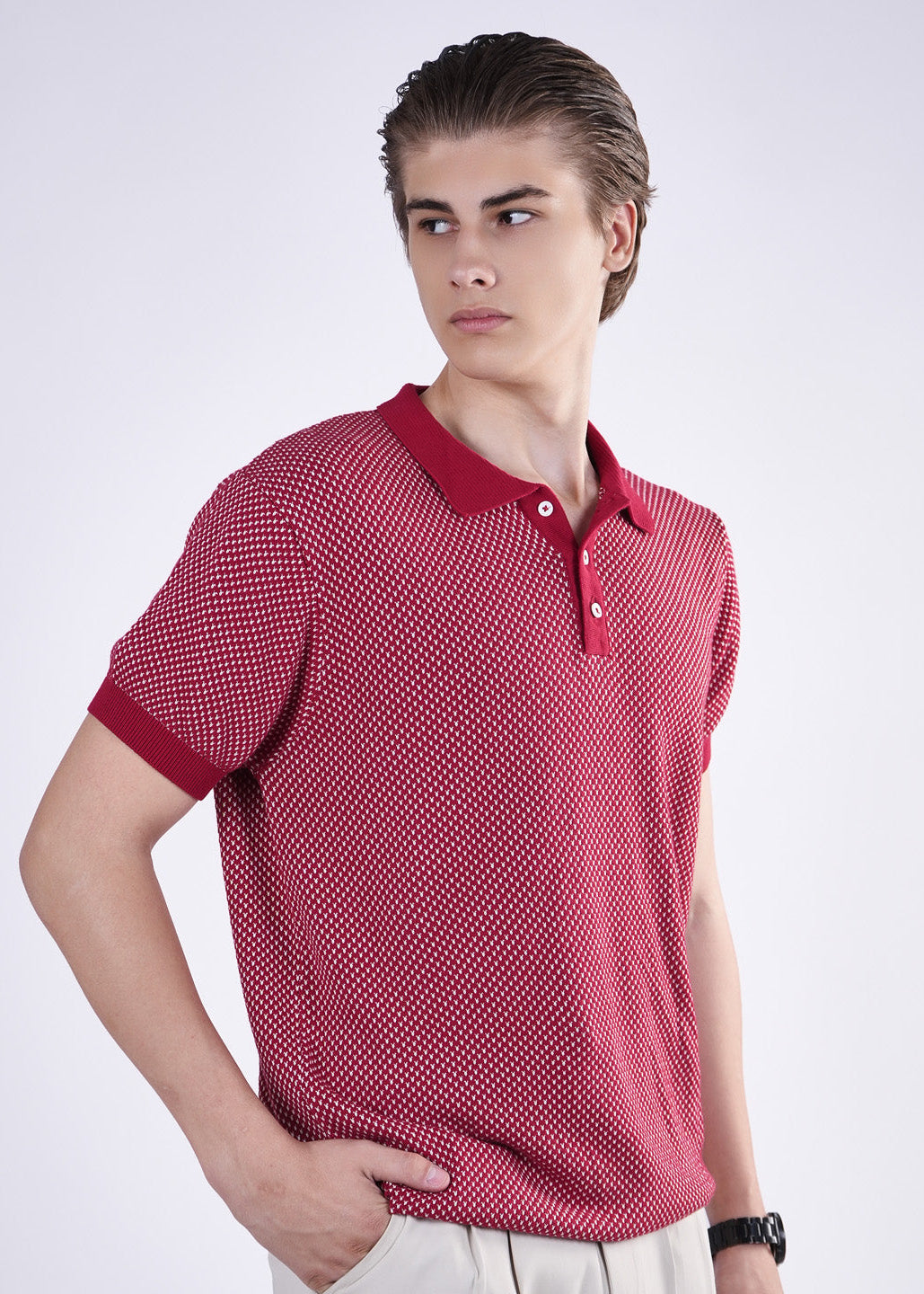 Man wearing a red patterned polo shirt on a white background