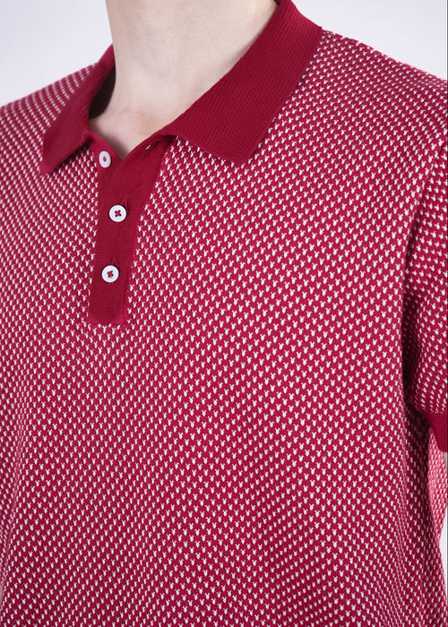 Red patterned polo shirt on a plain background