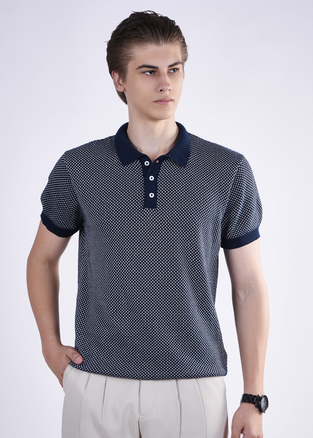 Man wearing a patterned polo shirt with a white background