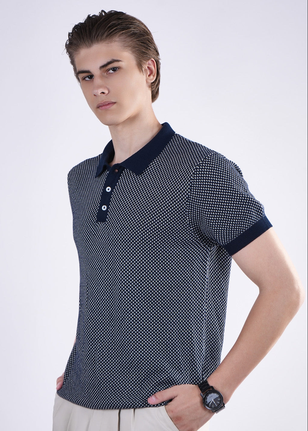 Man wearing a patterned polo shirt with a white background