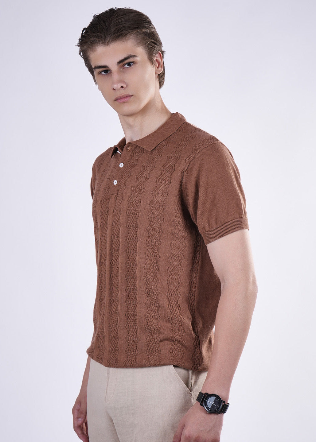 Man wearing a brown knitted polo shirt on a white background