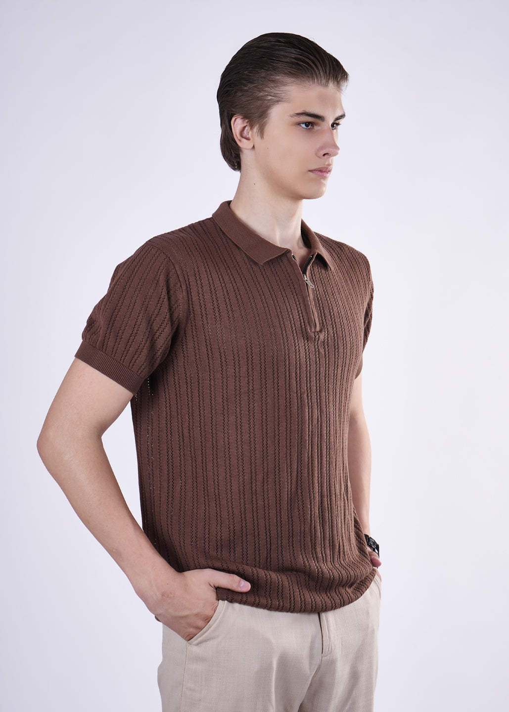 Man wearing a brown ribbed polo shirt on a white background