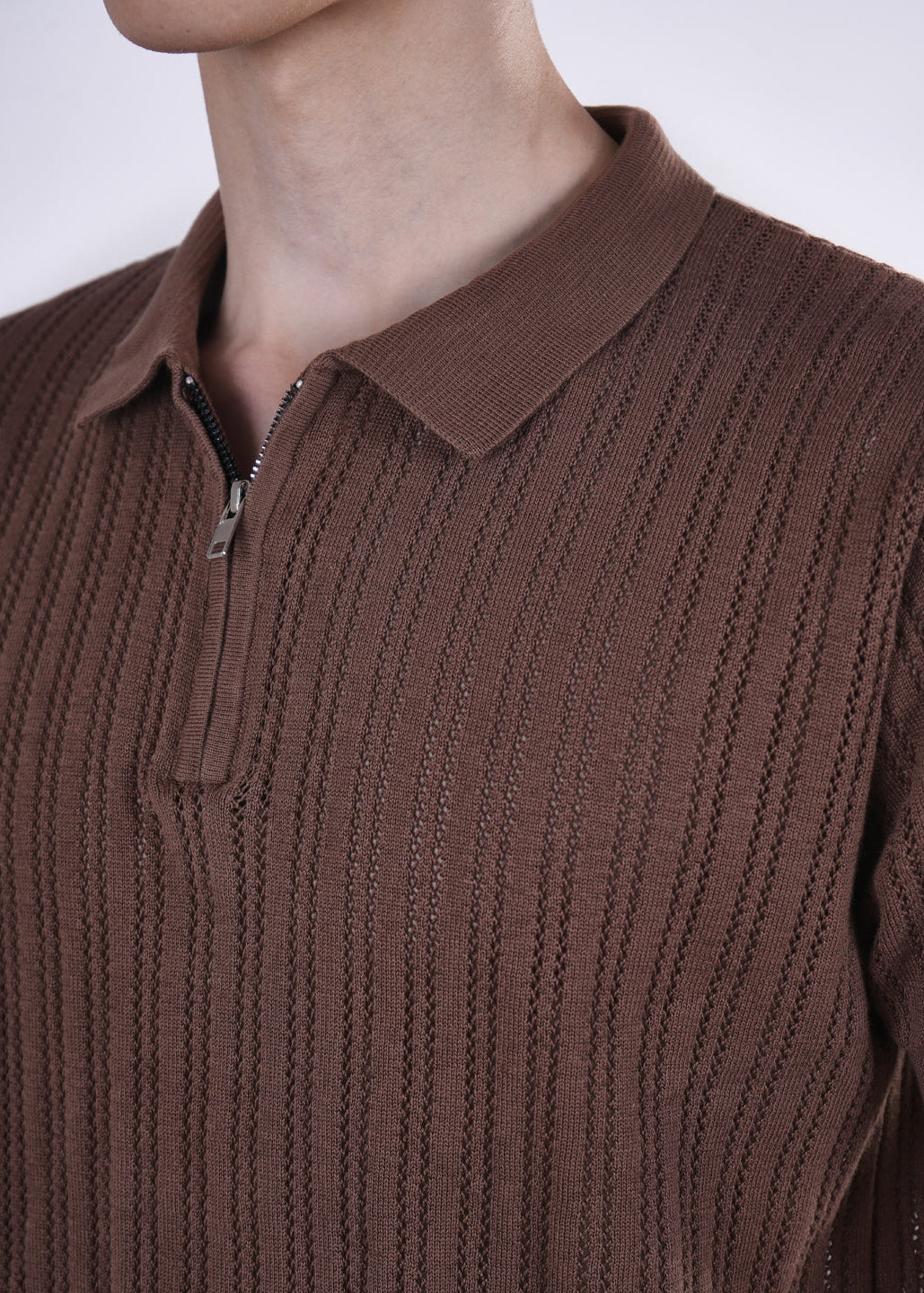 Brown ribbed sweater with a collar on a plain background