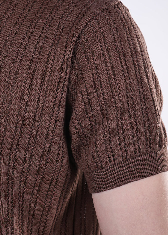 Brown knitted polo shirt on a plain background