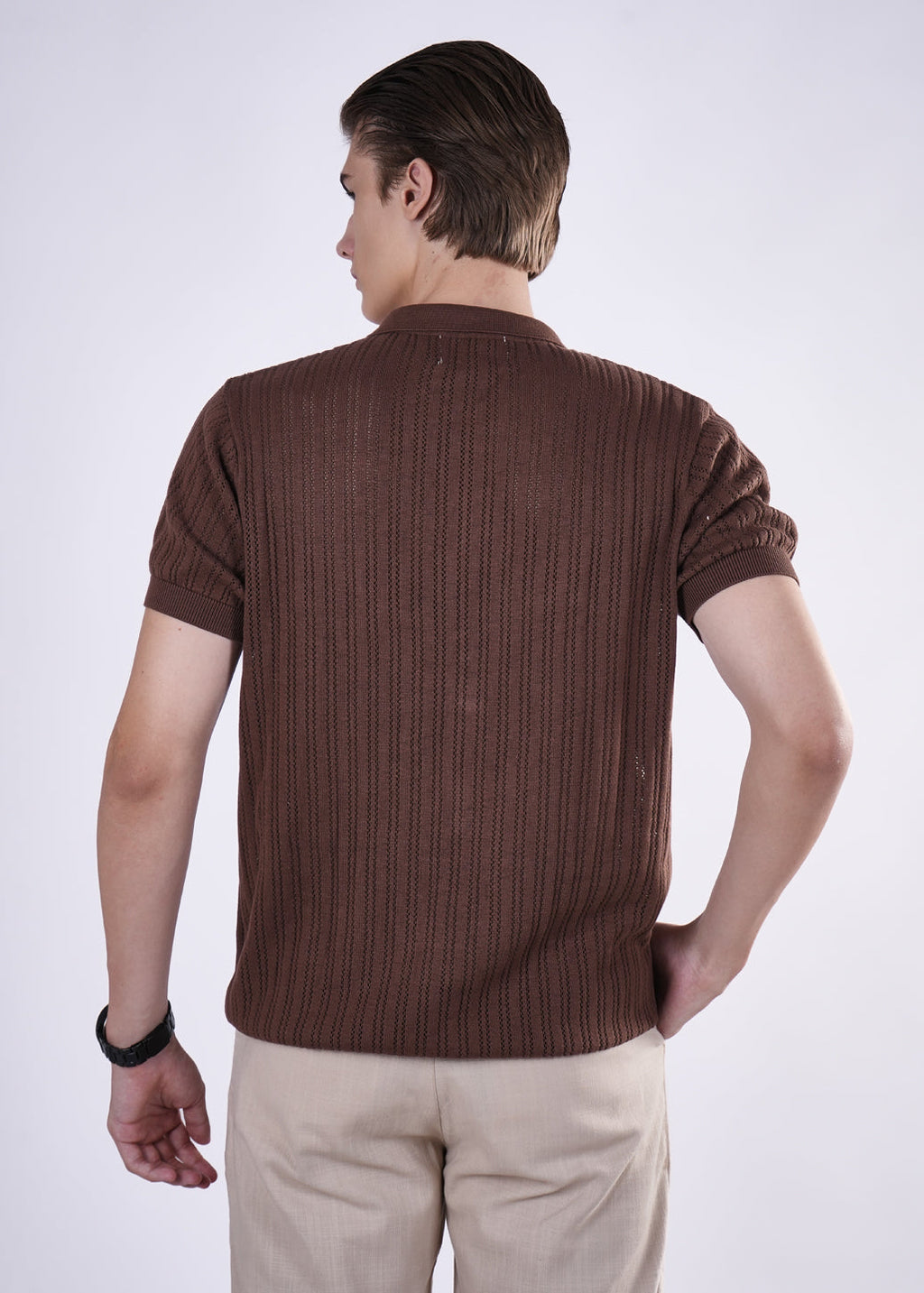 Man wearing a brown ribbed sweater on a white background