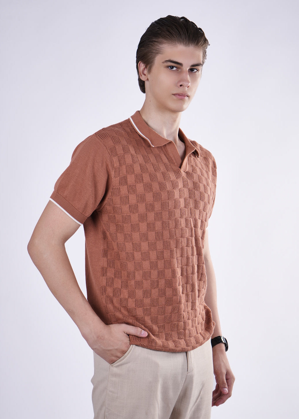 Man wearing a brown textured polo shirt on a white background