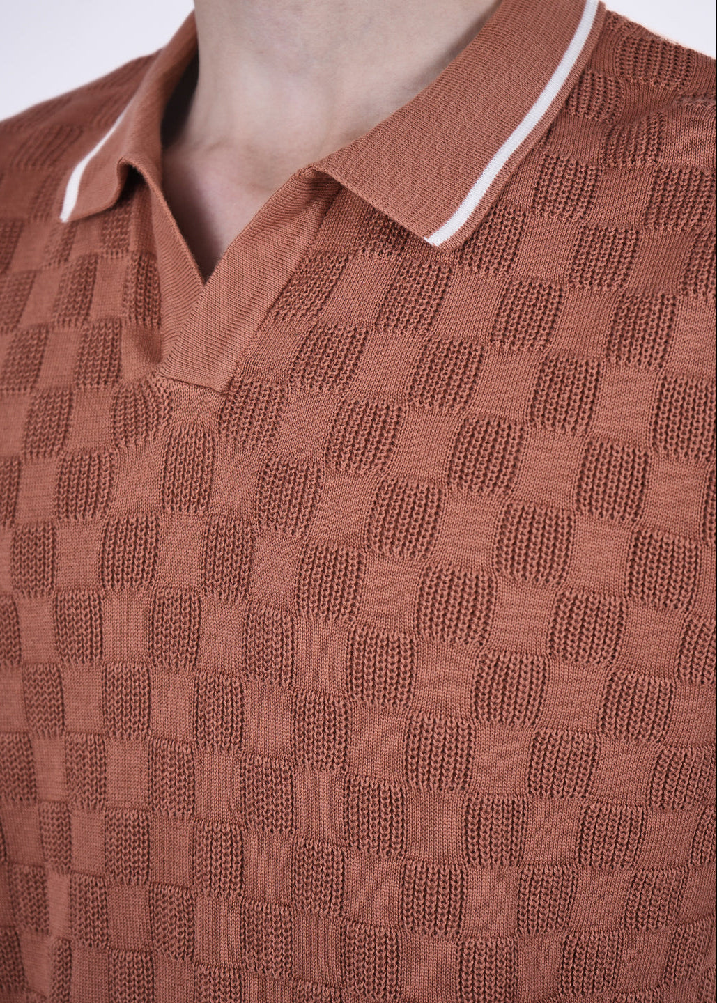 Brown textured polo shirt with white trim on a plain background