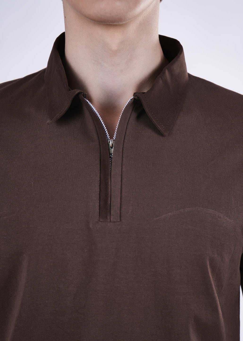 Brown polo shirt with a quarter zip on a mannequin against a light gray background