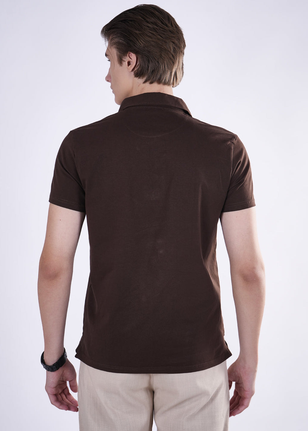 Man wearing a brown polo shirt on a white background