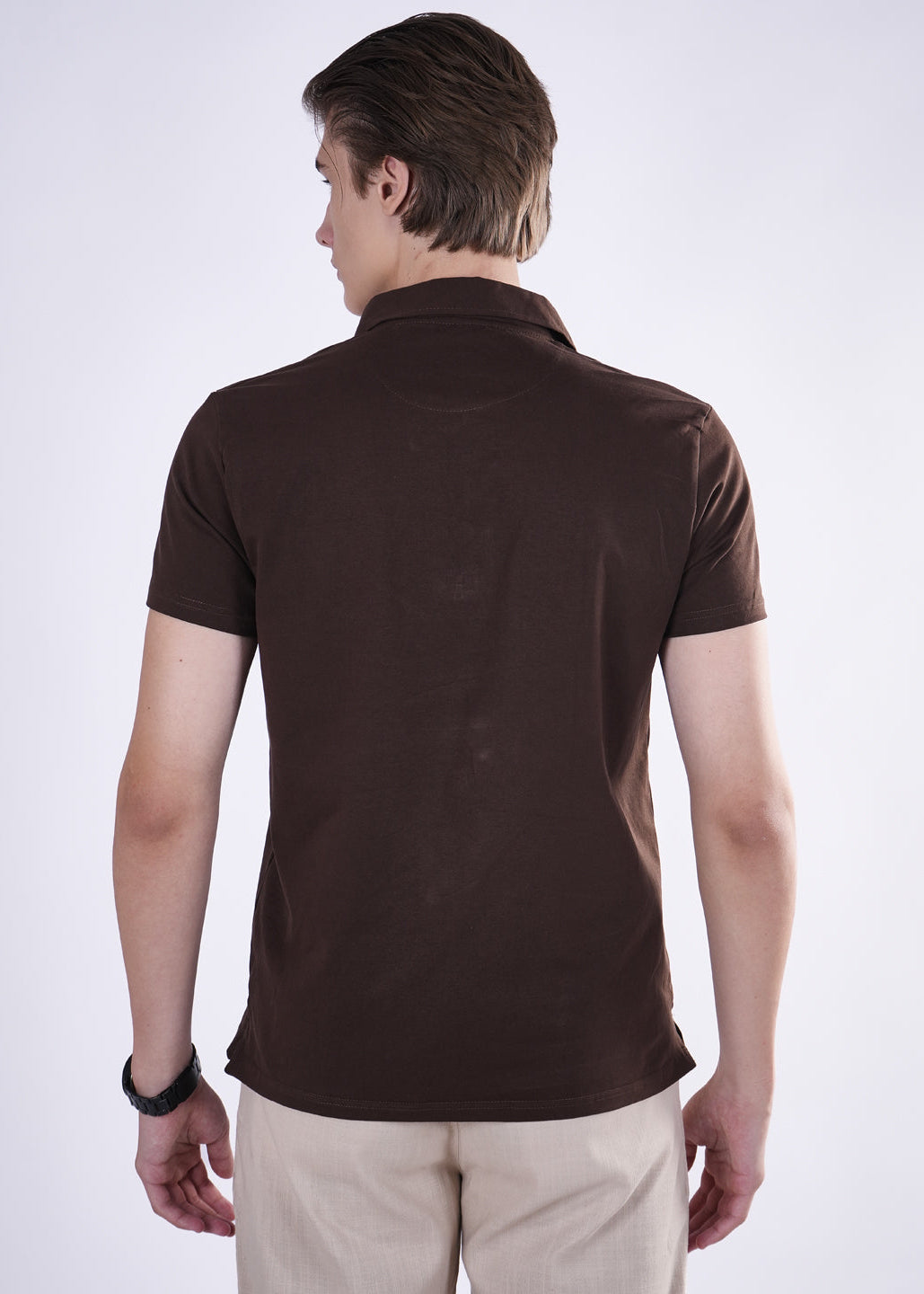 Man wearing a brown polo shirt on a white background