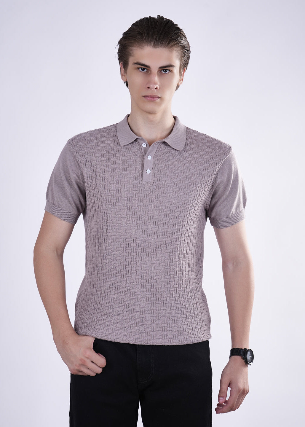 Man wearing a patterned polo shirt against a white background