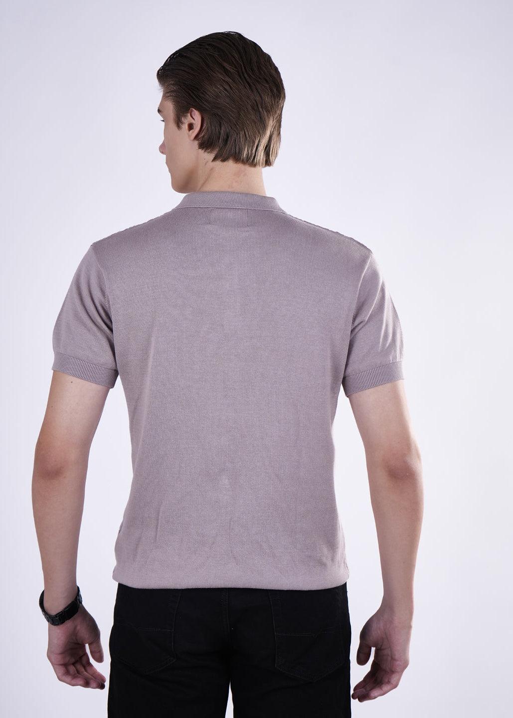 Man wearing a light purple polo shirt on a white background
