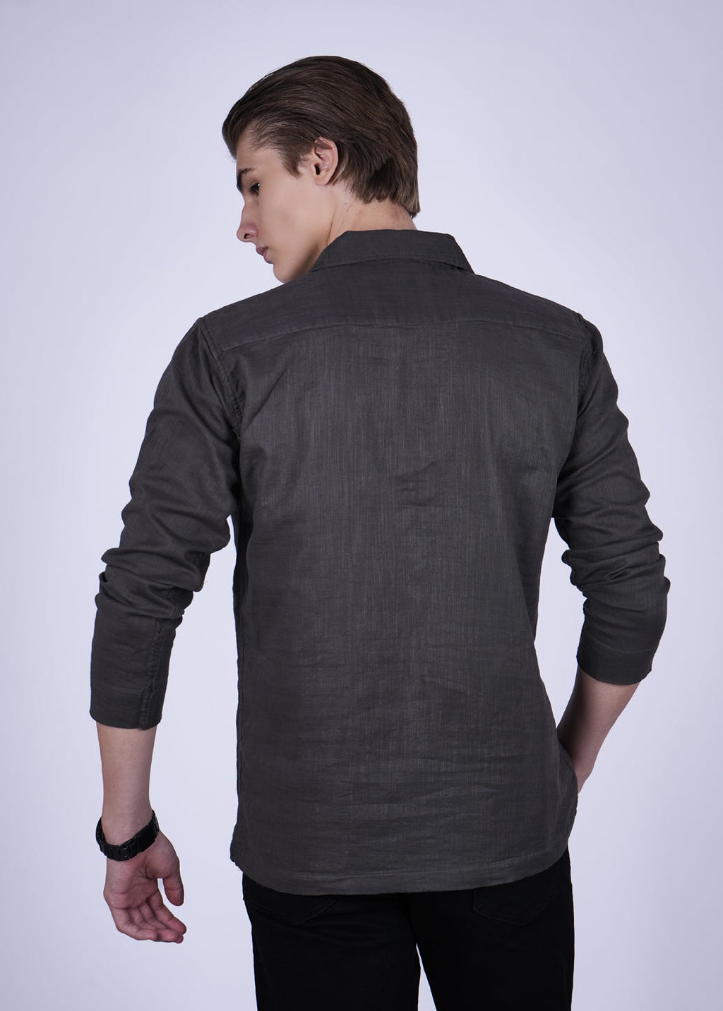 Person wearing a dark gray shirt on a white background