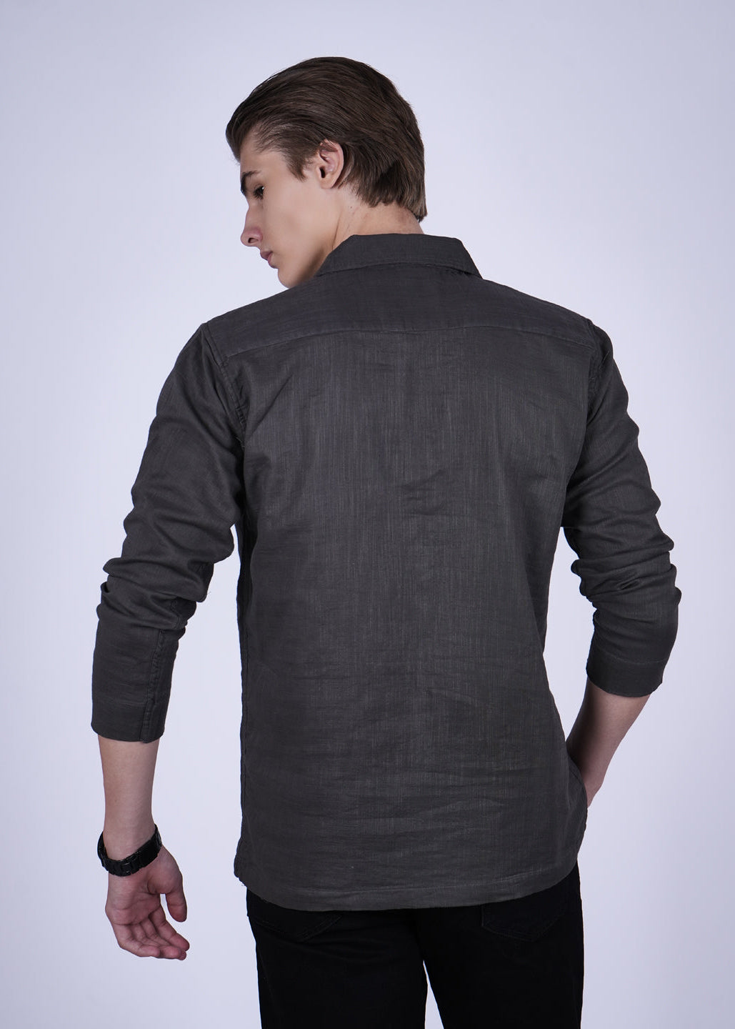 Person wearing a dark gray shirt on a white background