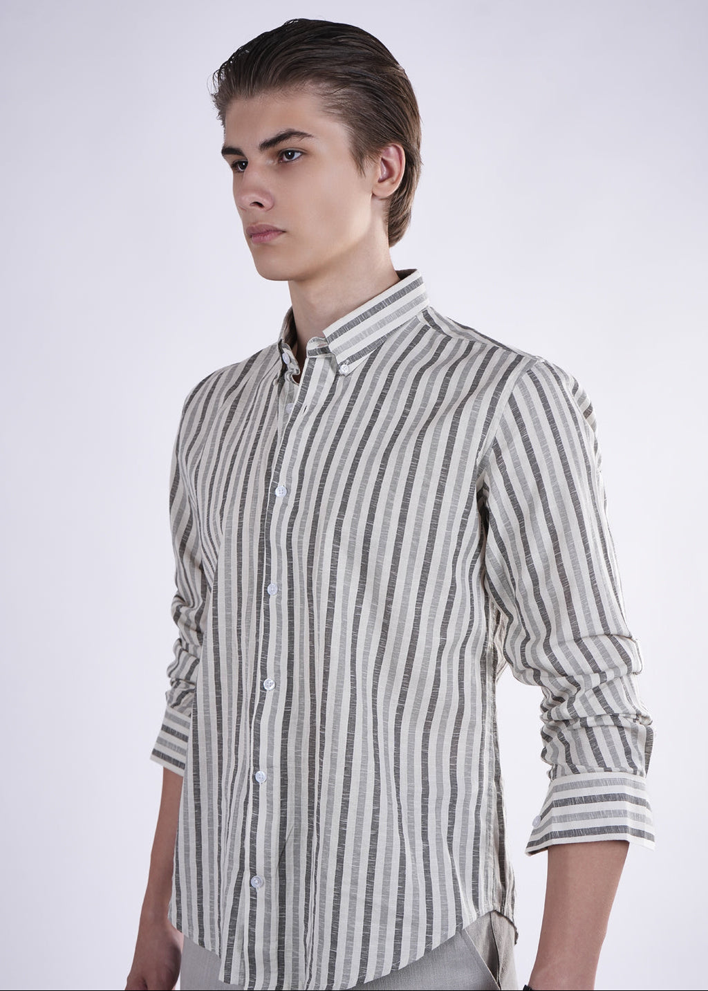 Man wearing a striped shirt against a plain background