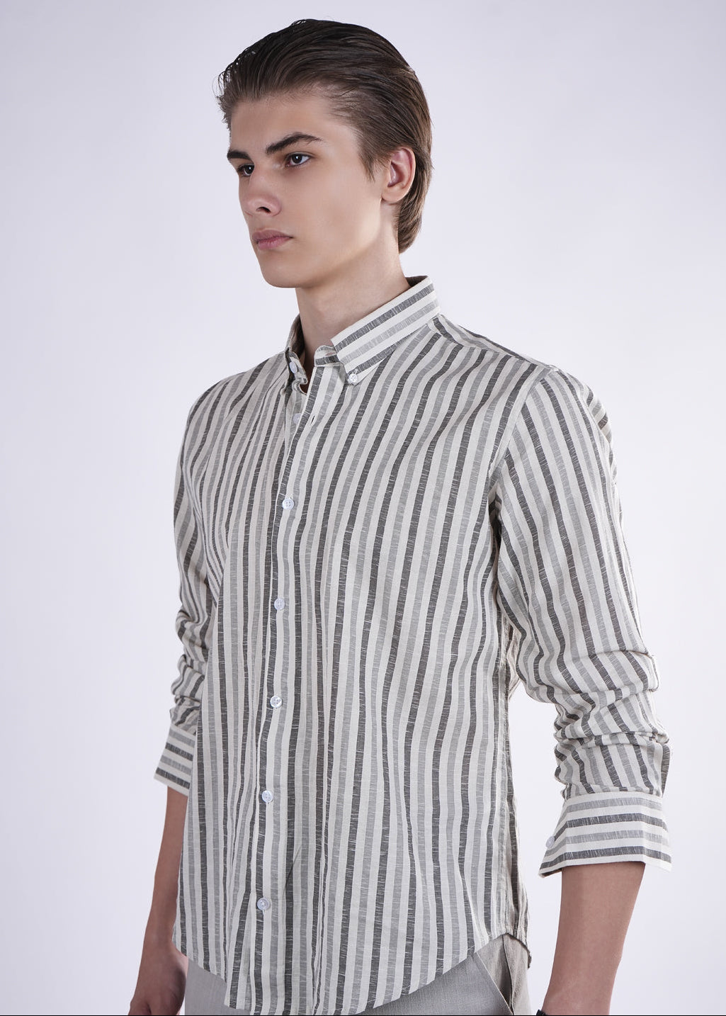 Man wearing a striped shirt against a plain background