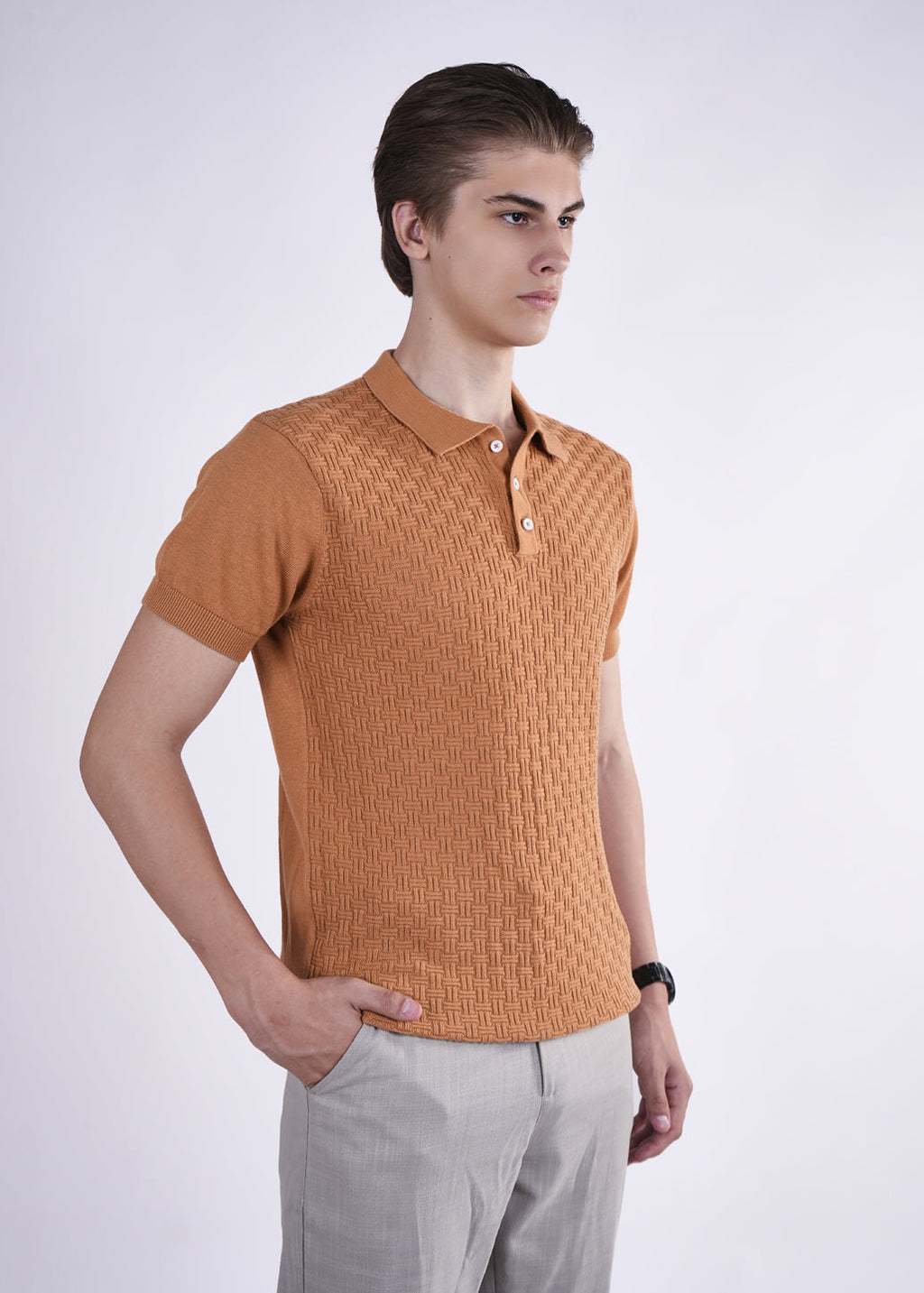 Man wearing a brown textured polo shirt against a white background
