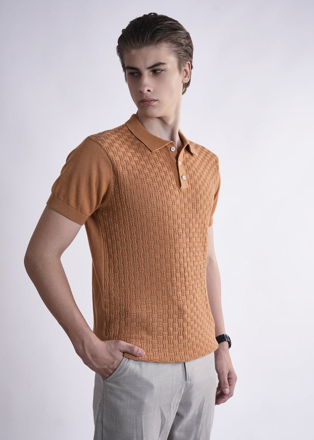 Man wearing a brown textured polo shirt against a white background