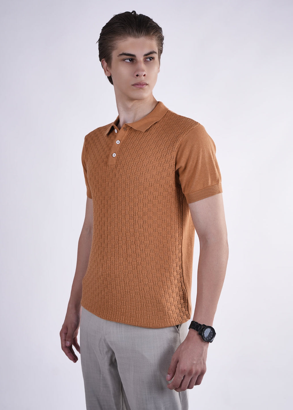 Man wearing a brown textured polo shirt against a white background