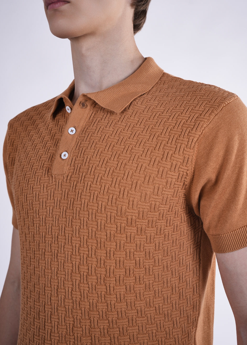 Brown textured polo shirt worn by a person on a white background