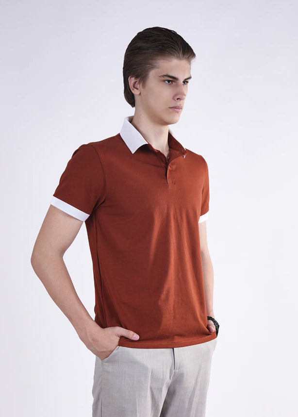 Man wearing a brown polo shirt with white trim on a white background