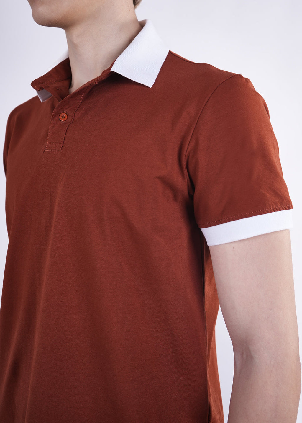 Brown polo shirt with white collar and cuffs on a white background