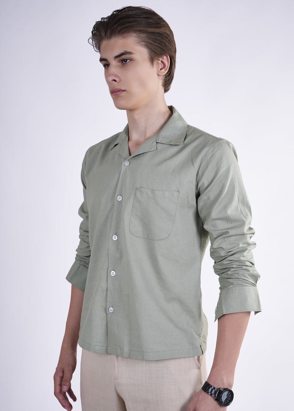 Man wearing a light green shirt on a white background