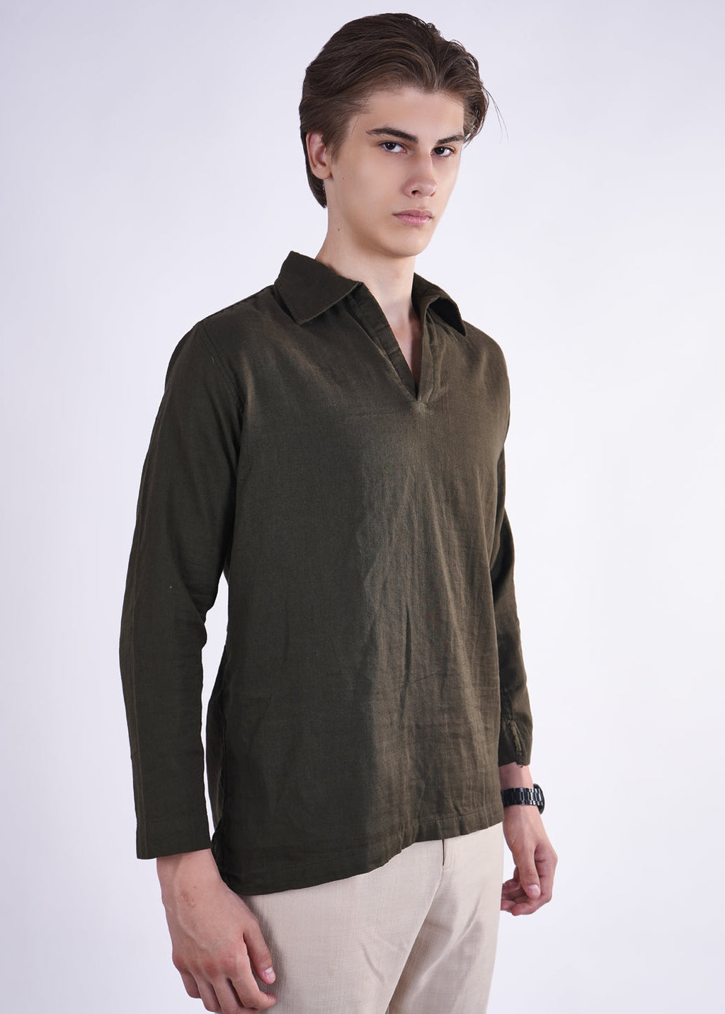 Man wearing a dark green shirt with a white background