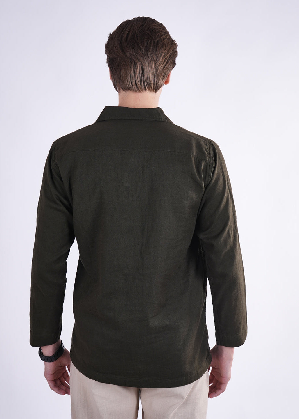 Man wearing a dark green shirt on a white background