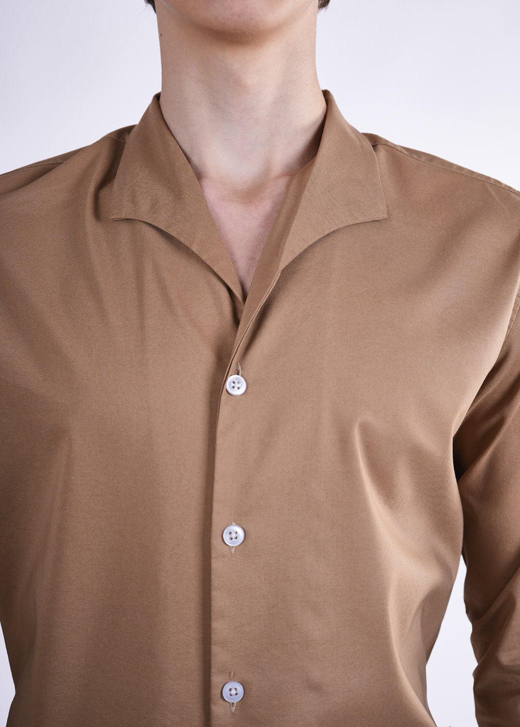 Brown shirt with buttons on a white background
