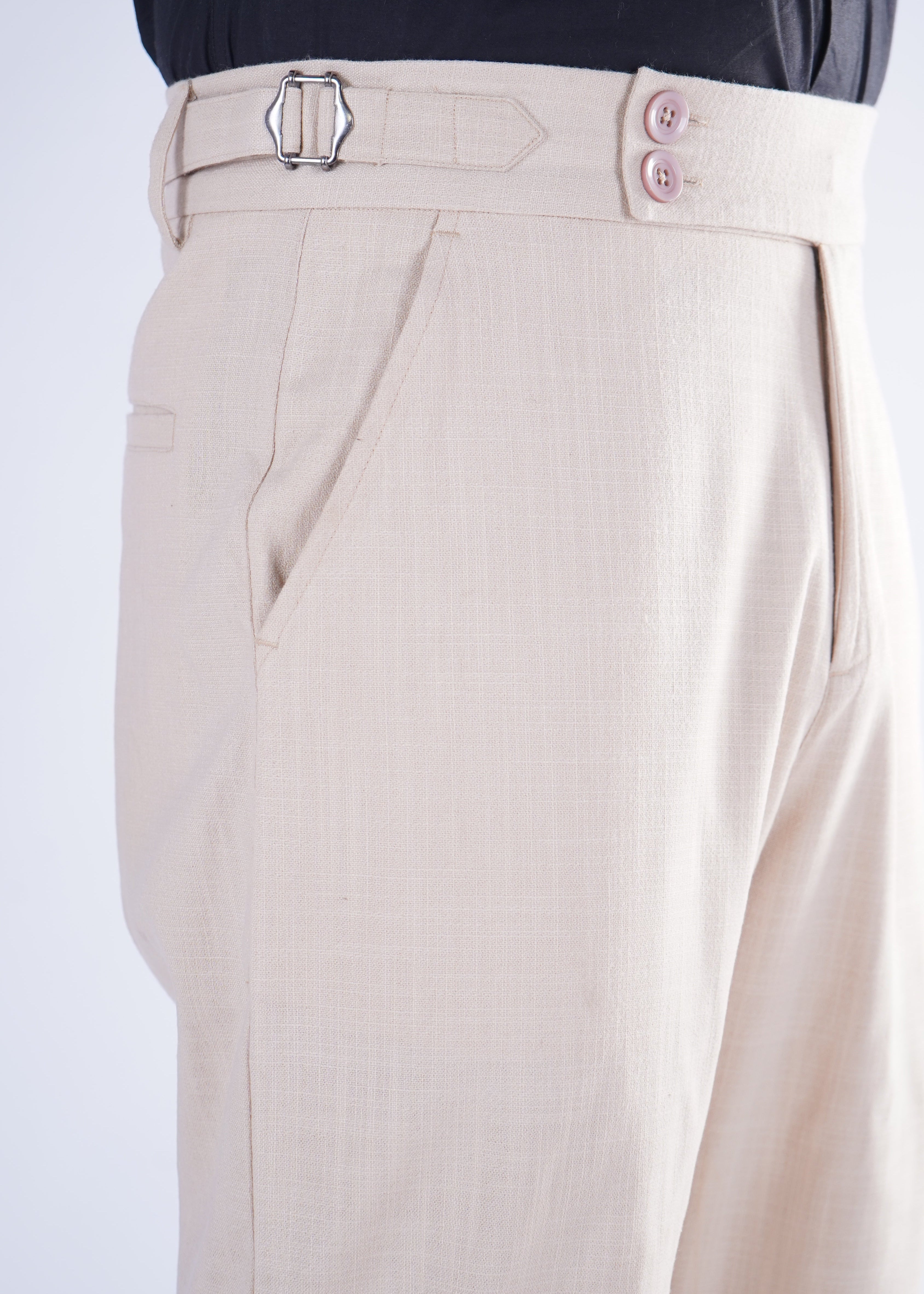 Close-up of beige pants with a white background
