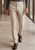 Man in gray polo shirt and beige pants walking in a modern indoor setting