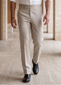 Man wearing a white shirt and beige pants in a modern architectural setting